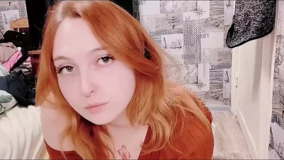Red-haired juicy babe in a sexy dress